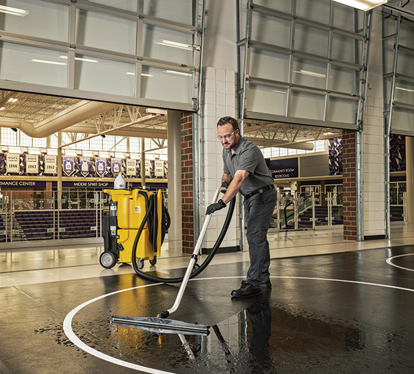 custodian cleaning wrestling mat